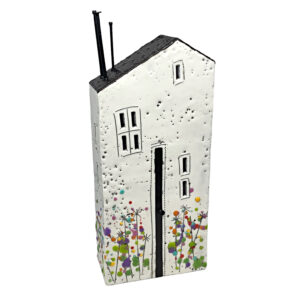 3-D encaustic white house with a black roof and multicoloured wildflowers by Brenda Walker.