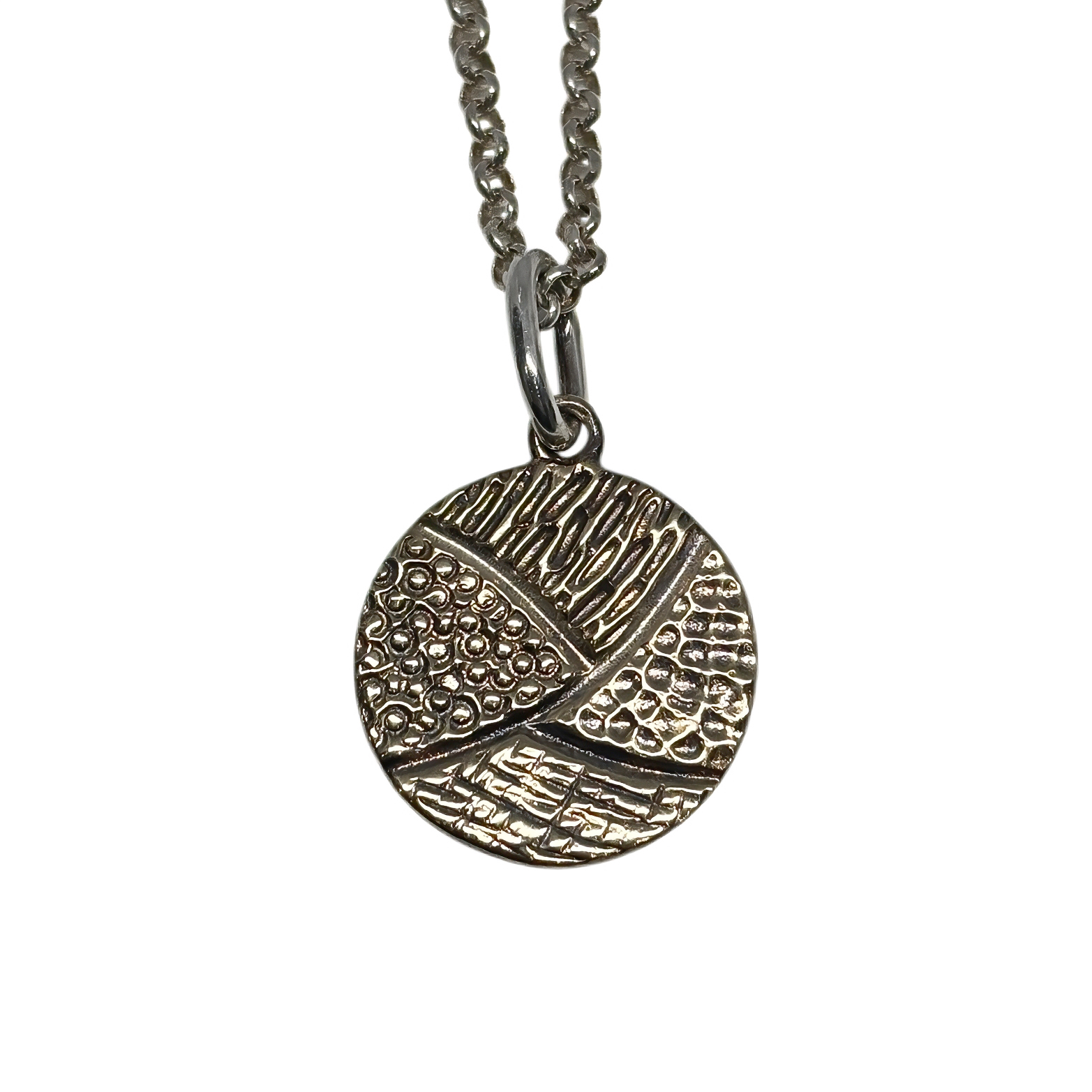 Handmade bronze + sterling silver circular disc pendant by Canadian jewelry artist Karyn Chopik at Effusion Art Gallery in Invermere, BC.